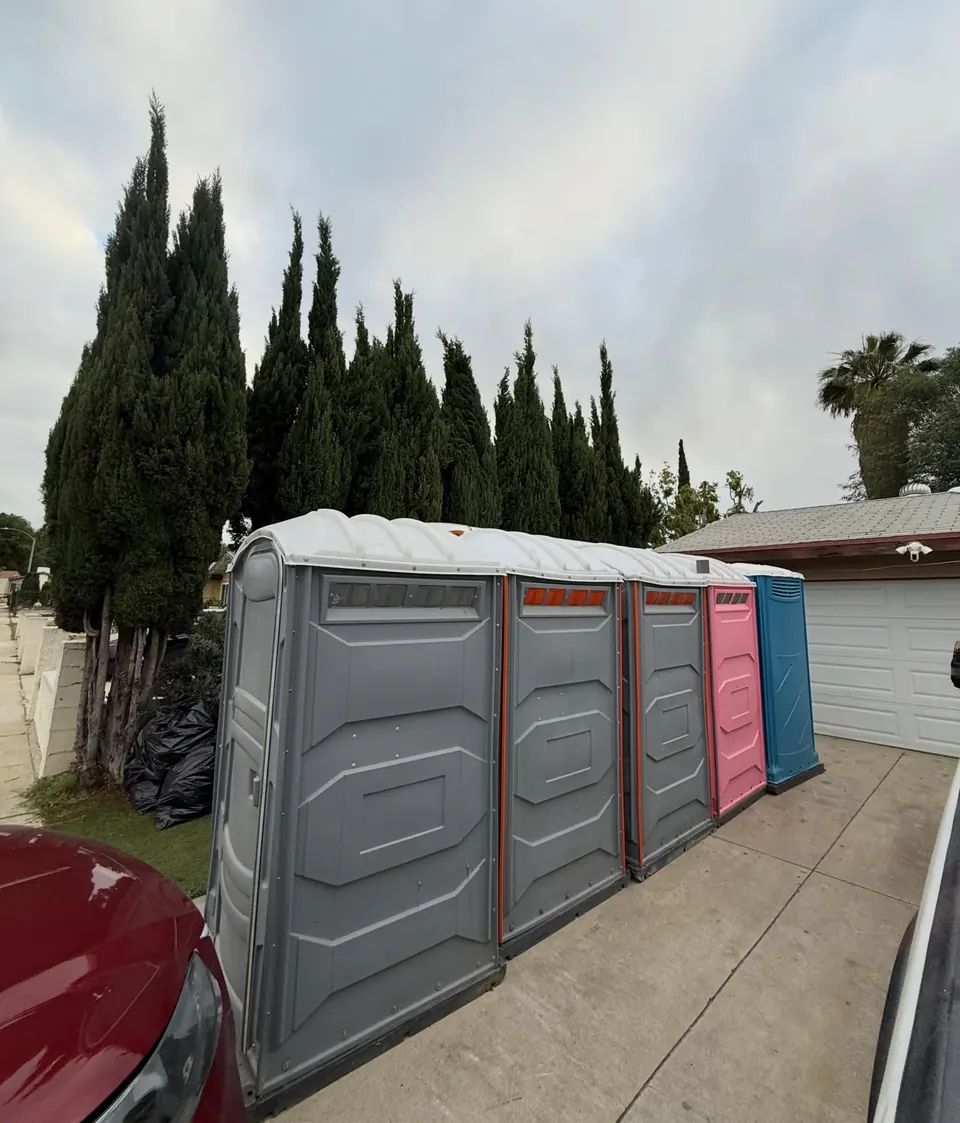 Large portable restroom alongside standard units