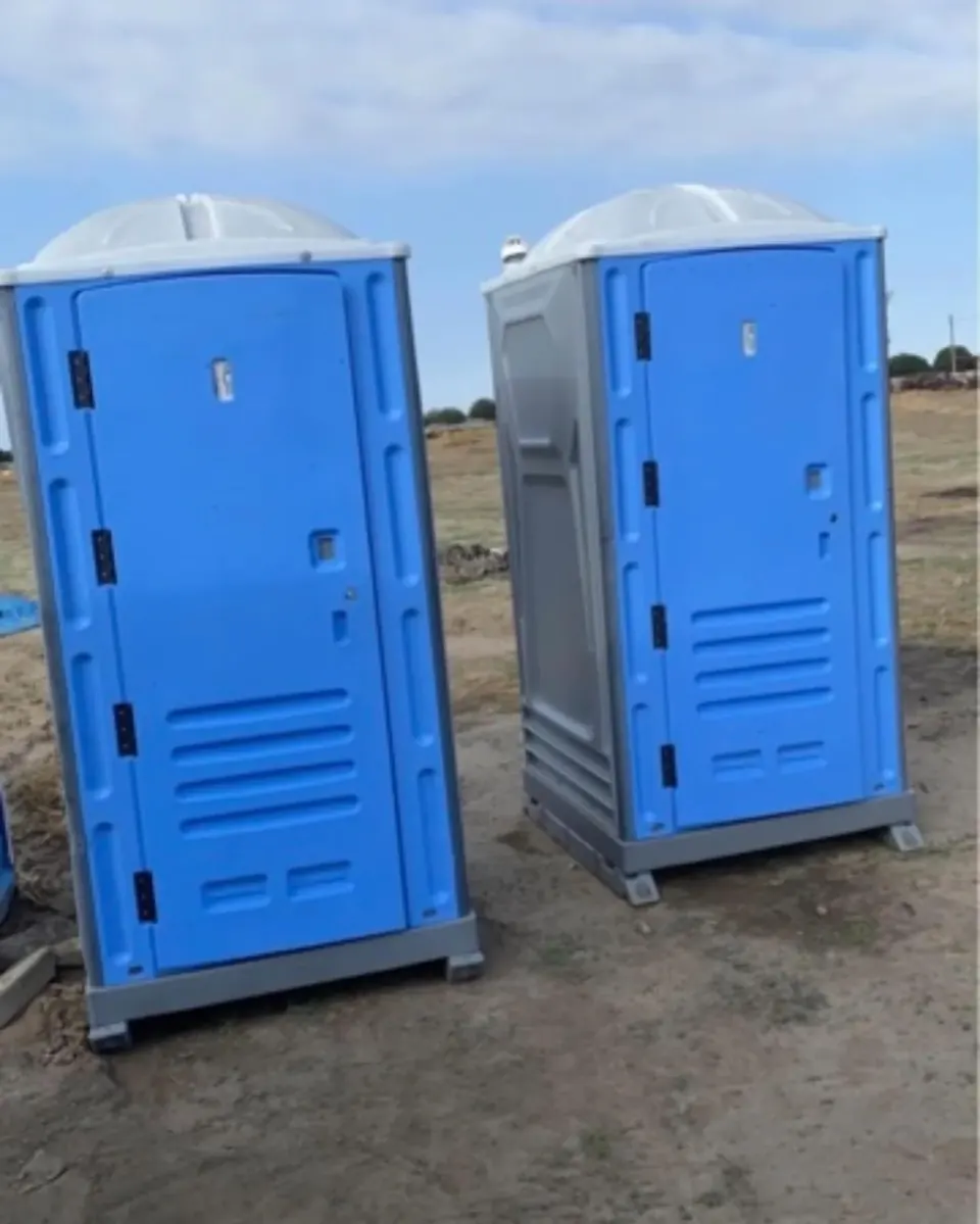 Two blue standard portable restrooms