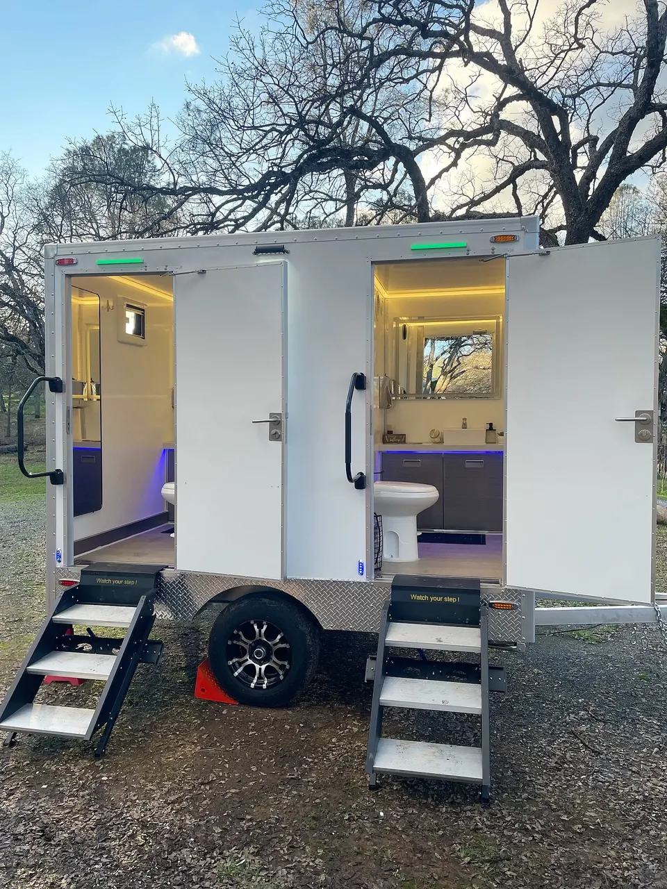 Restroom trailer with separate doors and entrance steps