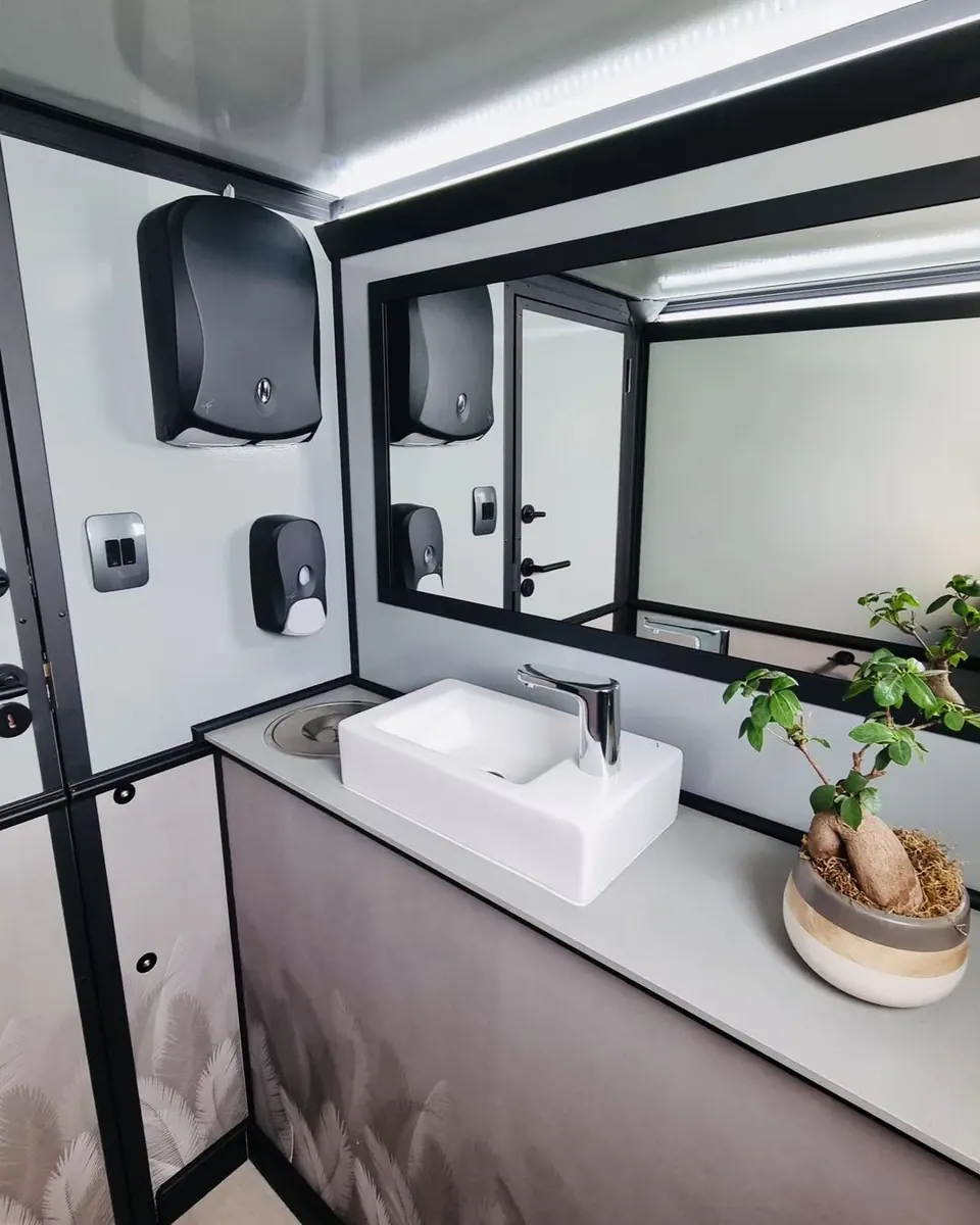 Sink and mirror inside a portable restroom trailer